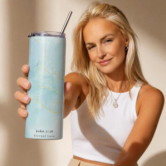 Woman holding a blue tumbler with a straw against a beige background