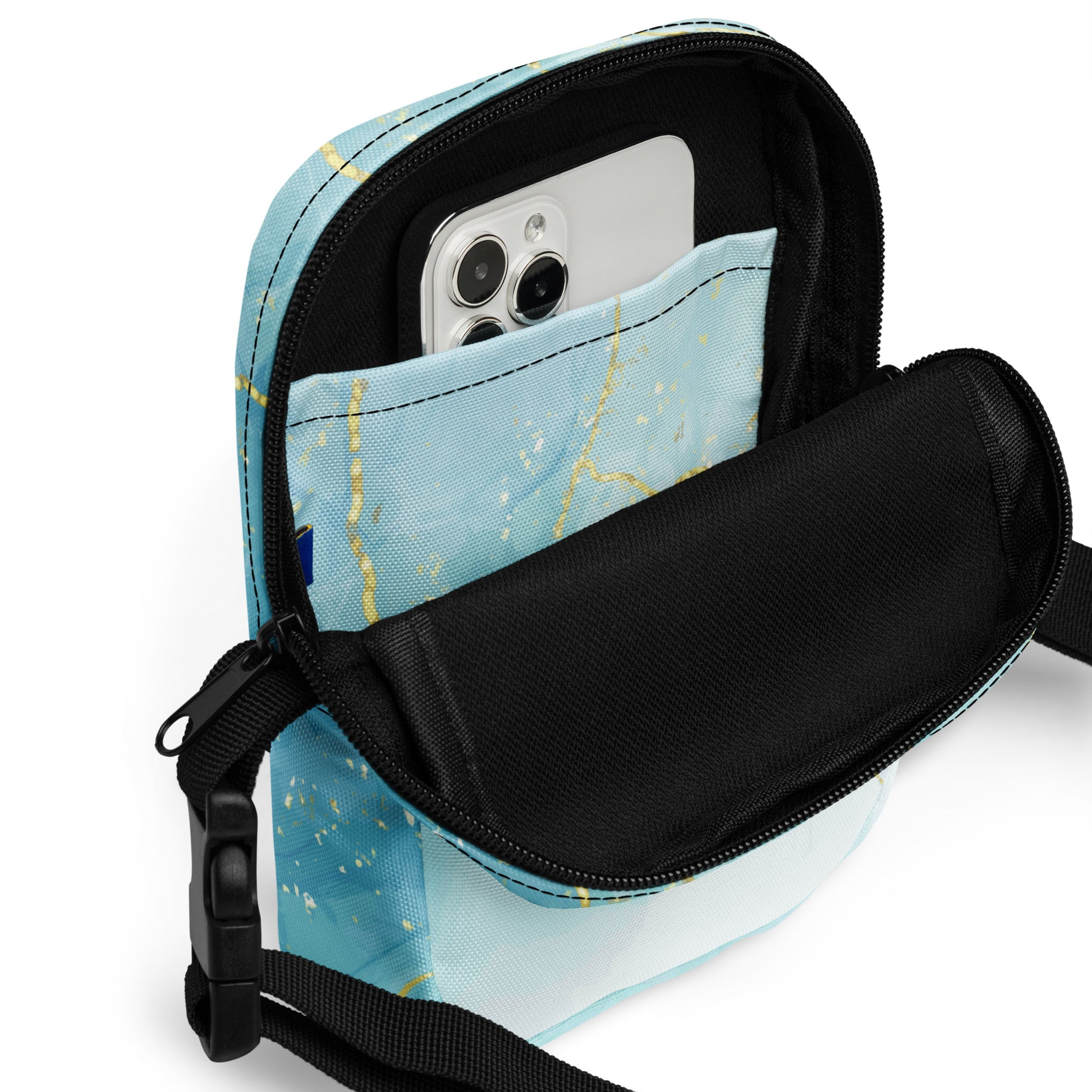 Blue crossbody bag with a phone inside on a white background