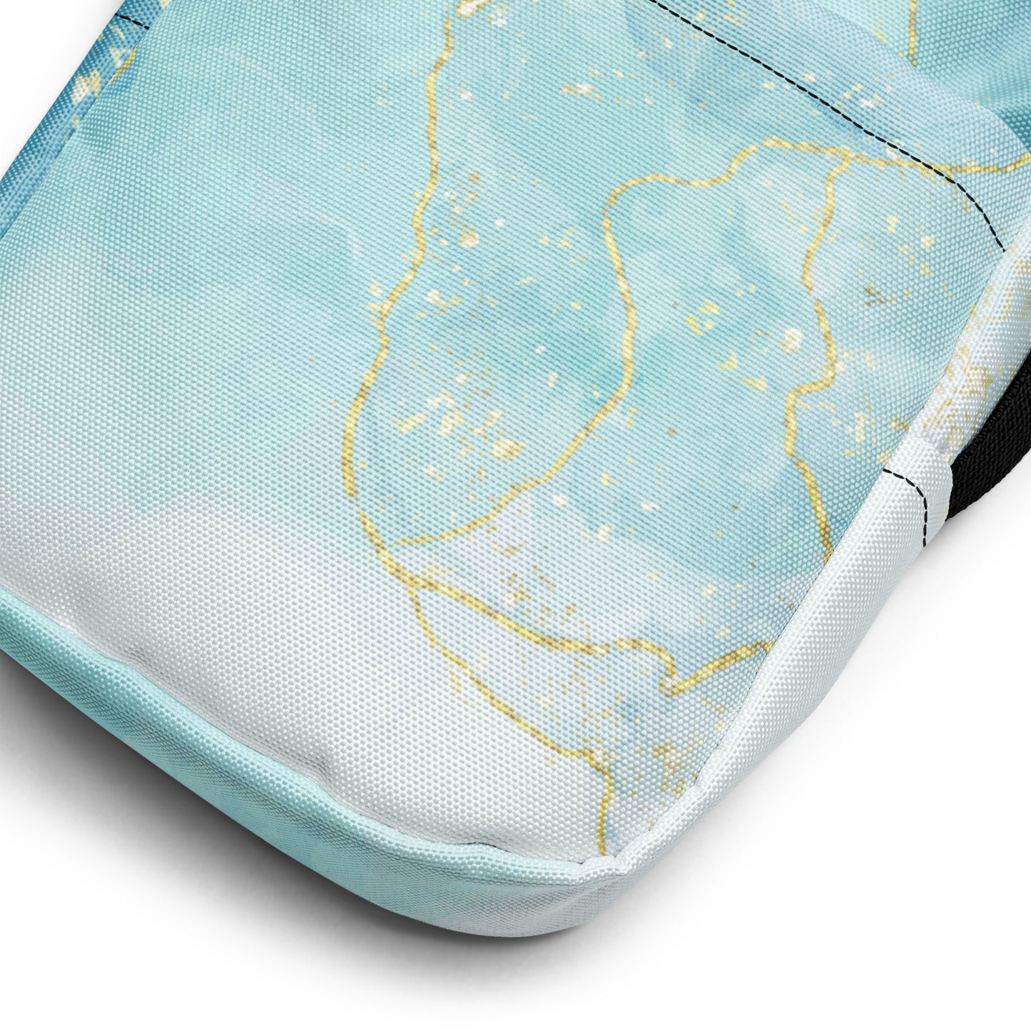 Close-up of a product with a light blue and white design featuring gold lines on a white background.